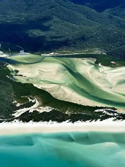 Coastal Scenery Prints: Aerial view of swirling sands create mesmerizing patterns against the turquoise waters near the lush