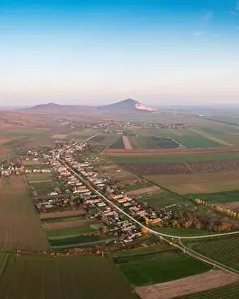 Mining Industry Prints: Aerial view of Szarsomlyo mountain with small village in Hungary