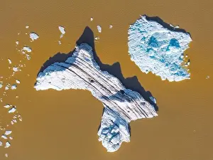 Blue Ice Prints: Aerial view taken by drone of iceberg in Fjallsjokull Glacier Lagoon during a summer day