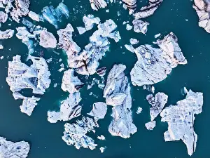 Summer Day Prints: Aerial view taken by drone of iceberg in Jokusarloon Glacier Lagoon during a summer day