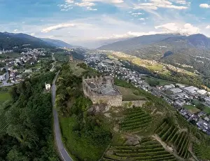 Aerial View - Terraced vineyards in the hills of Valtellina planted near monuments and old medieval ruins - Sondrio