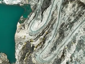 Quarry Prints: Aerial view of a transport truck hauling raw limestone through an open pit quarry