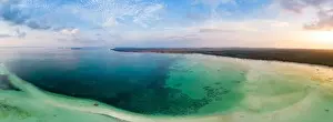 Aerial view tropical beach island reef caribbean sea dramatic sky at sunset sunrise