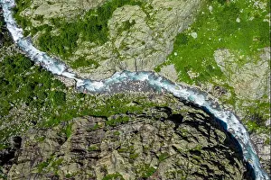 Geological Formation Prints: Aerial View of Turquoise Alpine River Carving a Rocky Gorge in the Swiss Alps