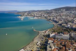 Coastal City Prints: Aerial view of the turquoise sea meeting the shore near the marina and the city