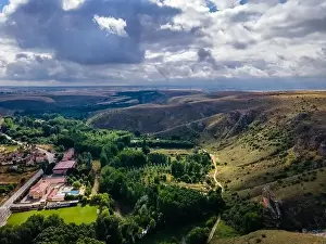 Segovia Prints: Aerial view of the valley formed by hills and buildings at the bottom of the ravine, Spain