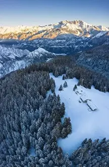 Seriana Valley Prints: Aerial view of the Valmezzana hut and Presolana massif during a winter sunrise from Monte Pora