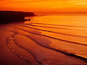 Swell Prints: Aerial view of warm sunset or sunrise and ocean with silhouette of perfect waves