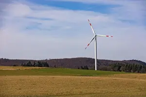 Alternative Energy Prints: Aerial view of a wind turbine with red and white rotor blades in a rural landscape