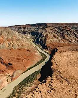 Rock Formations Prints: Aerial view of the winding river carves through the rugged canyon