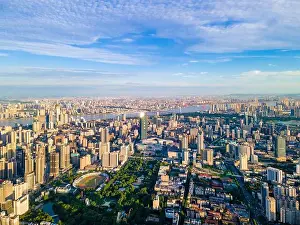 Blue Bridge Prints: Aerial view of Wuhan skyline and Yangtze river with supertall skyscraper under construction in Wuhan Hubei China