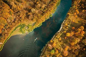 Motorboat Prints: Aerial view of yellow forest woods and river marsh bog in autumn landscape