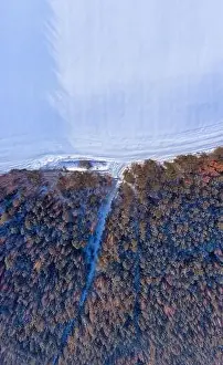 Amazing Landscape Prints: Aerial winter landscape. Snowy frost covered forest and field with tracks in snow