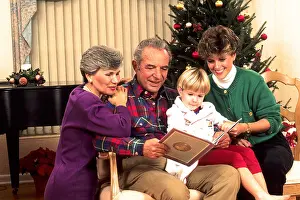 Presents Prints: Affluent three generation family enjoys the gift giving spirit of the Christmas season