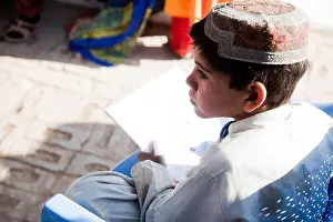 Childcare Prints: An Afghan boy uses a coloring book at the women's center near Forward Operating Base Pasab