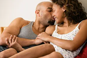 Heterosexual Prints: African couple kissing in bed