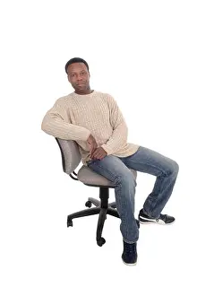 Worry Prints: African man sitting on office chair and thinking
