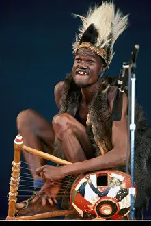 Entertain Prints: African Musician from Cote d'Ivoire (Ivory Coast) in West Africa playing Harp Lyre