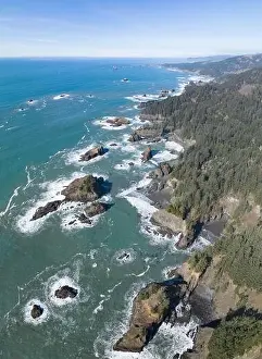 Afternoon sunlight shines on the scenic southern coast of Oregon. This rugged region is found in the Samuel H. Boardman State Scenic Corridor