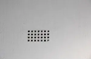 Brick Wall Prints: An air brick isolated in a white cement plastered wall indoor in a private house image with copy space