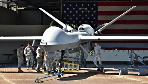 Reconnaissance Prints: An Air Force MQ-9 Reaper drone undergoing maintenance in a hangar at Columbus Air Force Base