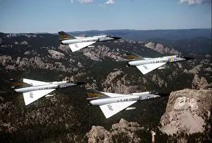 Interceptor Prints: An air-to-air right side view of four F-106 Delta Dart aircraft in a diamond formation