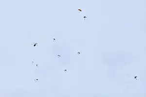 Airborne forces paratroopers soaring holding Flag of Russia and flags of military units, military exercise for celebration of Airborne Forces Day with
