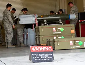 Airmen from the 432nd Maintenance Squadron munitions flight prepare six GBU-12 Paveway II laser-guided bombs at Creech