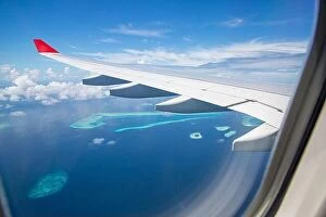 Images Dated 10th December 2015: Airplane interior with window view of Maldives island. Concept of travel and air transportation