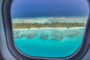 Images Dated 3rd February 2022: Airplane window with beautiful Maldives island view. Luxury summer holiday travel tourism background