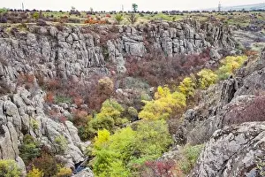 Aktovsky Canyon, Ukraine. Autumn trees and large stone boulders around
