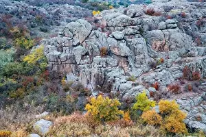 Aktovsky Canyon, Ukraine. Autumn trees and large stone boulders around