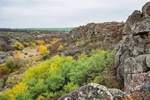 Mertvovod Prints: Aktovsky Canyon, Ukraine. Autumn trees and large stone boulders around