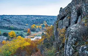 Aktovsky Canyon, Ukraine. Autumn trees and large stone boulders around