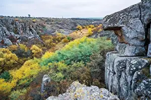 Aktovsky Canyon, Ukraine. Autumn trees and large stone boulders around