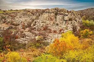 Aktovsky Canyon, Ukraine. Autumn trees and large stone boulders around
