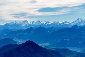 Blue Mountain Prints: alps mountain range in blue appearance due to aerial perspective, covered with snow