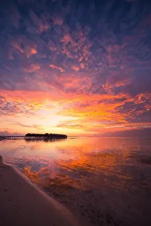 Amazing abstract background. Beautiful sunset colors in Maldives. Long jetty and luxury overwater villas