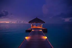Amazing abstract background. Beautiful sunset colors in Maldives. Long jetty and luxury overwater villas