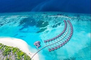 Images Dated 11th August 2019: Amazing aerial landscape, Maldives island, luxury water villas resort and wooden pier