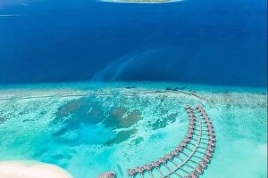 Images Dated 11th August 2019: Amazing aerial landscape, Maldives island, luxury water villas resort and wooden pier
