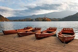 Images Dated 26th October 2018: Amazing autumn view of Bled lake in Julian Alps, Slovenia. Wooden boat on city pier