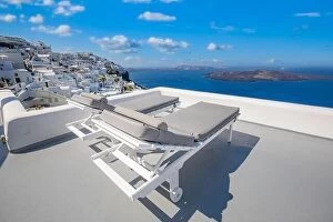 Images Dated 26th July 2021: Amazing destination scenic. Two chairs umbrella on caldera terrace in Santorini, Greece