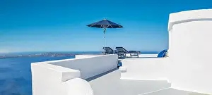 Caldera Prints: Amazing destination scenic. Two chairs umbrella on caldera terrace in Santorini