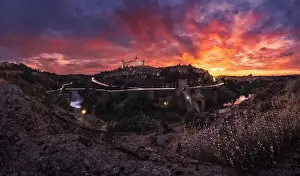Road City Prints: Amazing drone view of aged town with old buildings glowing during sunset and luminous highway in long exposure