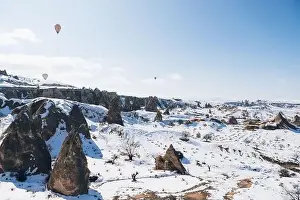 Cappadocia Prints: Amazing drone view of colorful hot air balloons flying over old Uchisar settlement