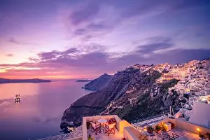 Amazing landscape evening view of Fira, caldera, volcano of Santorini, Greece with cruise ships at sunset. Travel destination cloudy dramatic sky