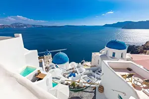 Amazing panoramic landscape, luxury travel vacation. Oia town on Santorini island, Greece. Traditional and famous houses and churches with blue domes