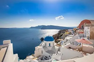 Amazing panoramic landscape, luxury travel vacation. Oia town on Santorini island, Greece. Traditional and famous houses and churches with blue domes