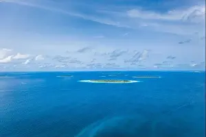 Amazing seascape, beautiful turquoise tropical ocean water with boat on it top view aerial photo. Maldives Indian ocean, aerial seascape, landscape